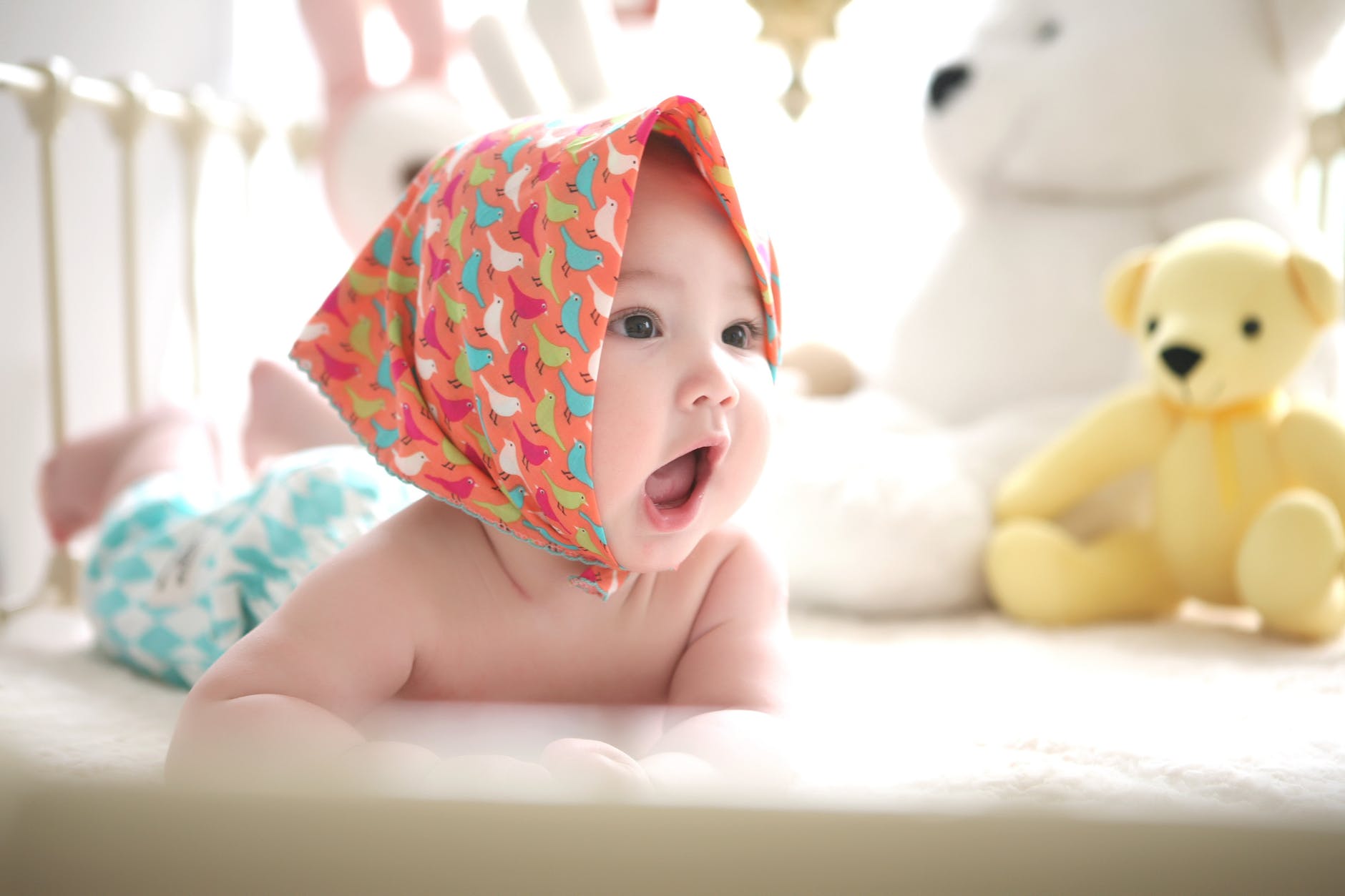 toddler wearing head scarf in bed